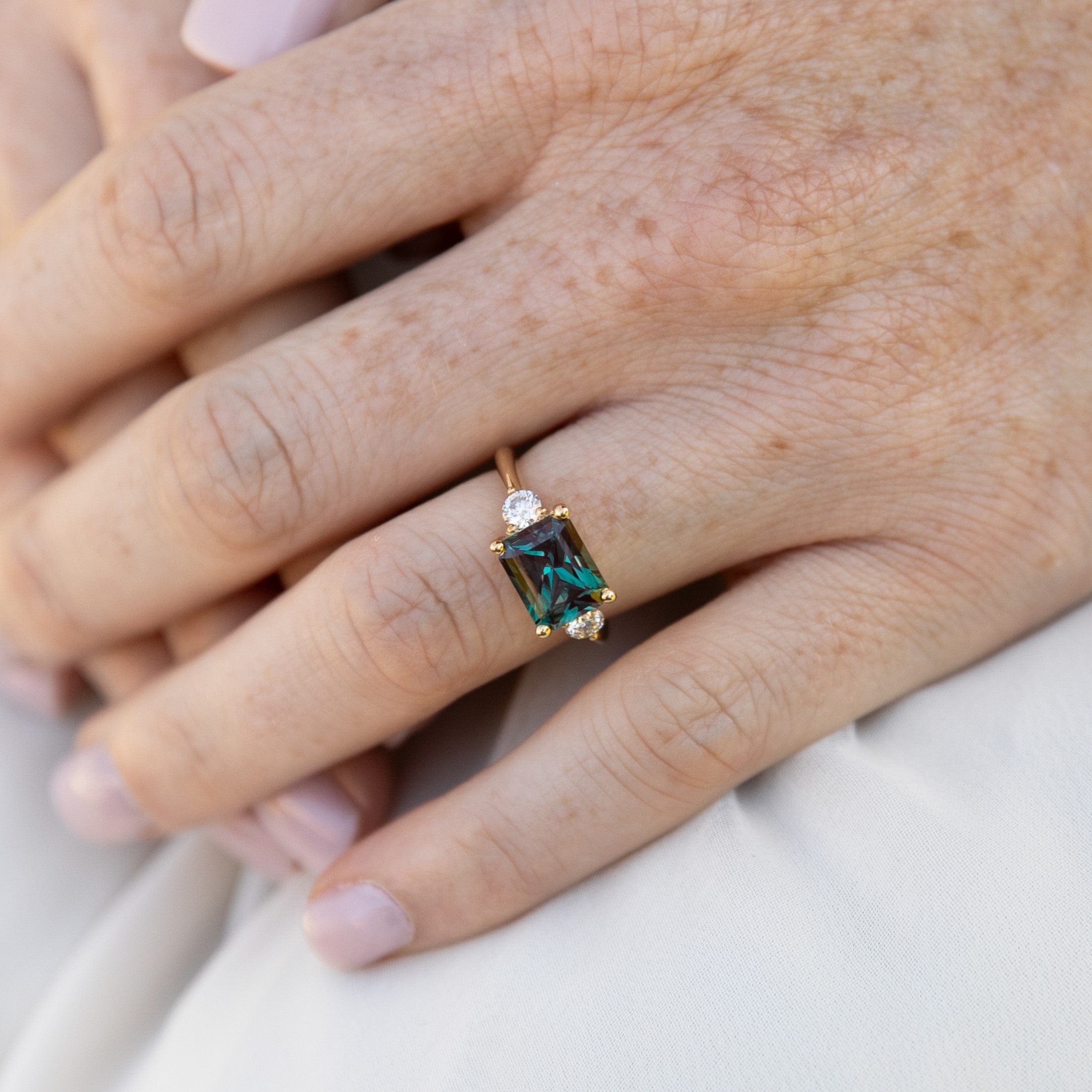 east-west-alexandrite-diamond-engagement-ring-yellow-gold-on-hand2