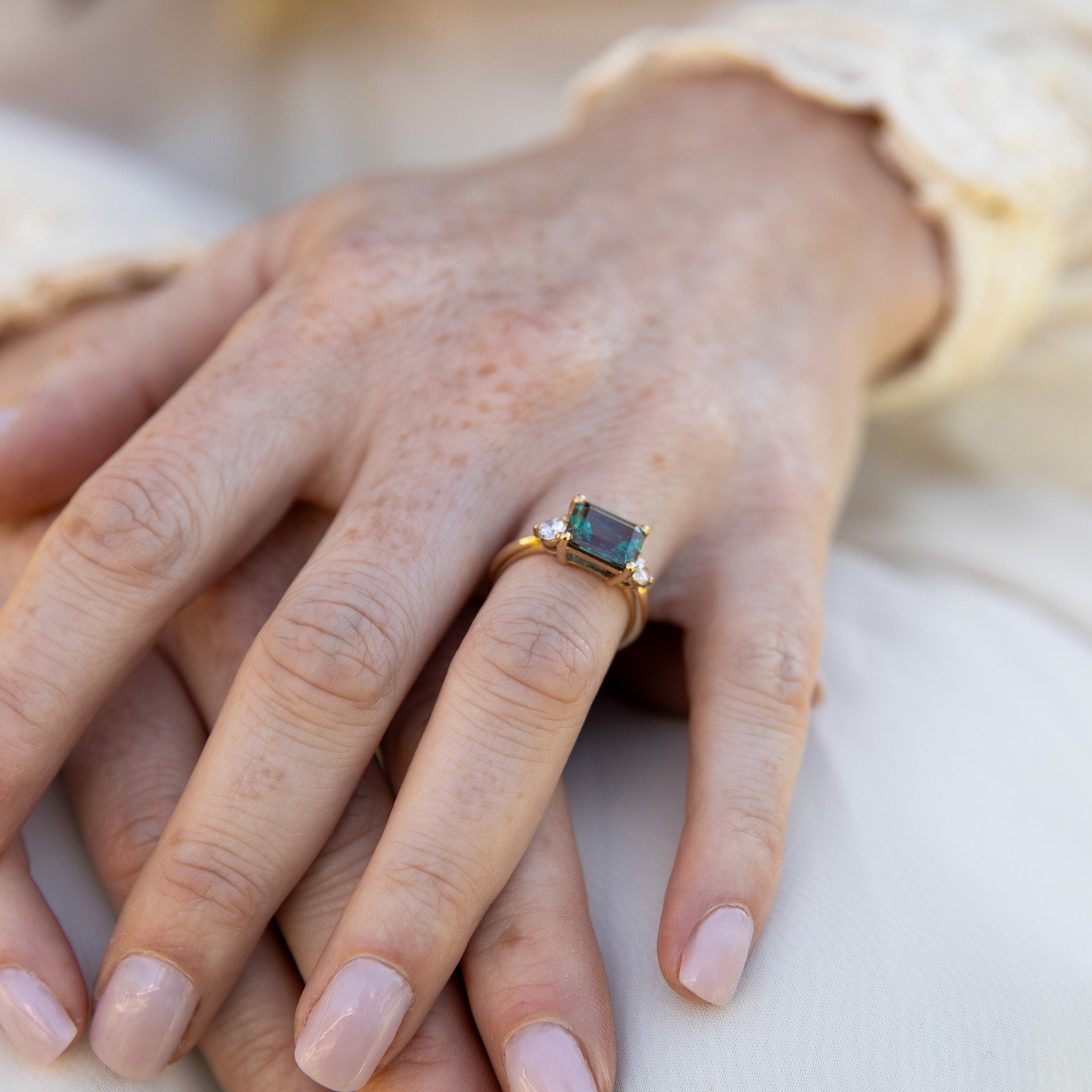 east-west-alexandrite-diamond-engagement-ring-yellow-gold-on-hand3