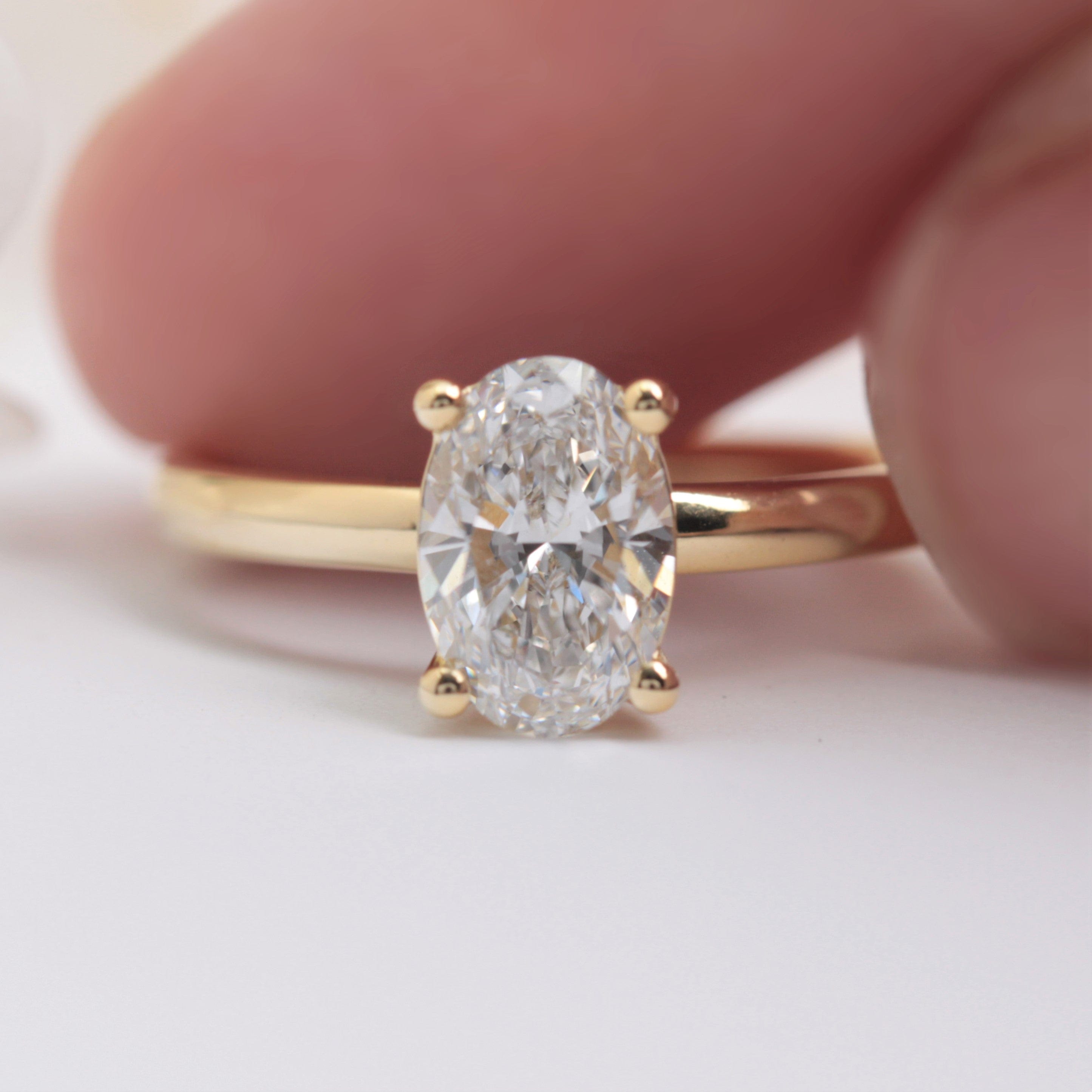 oval solitaire lab diamond engagement ring yellow gold