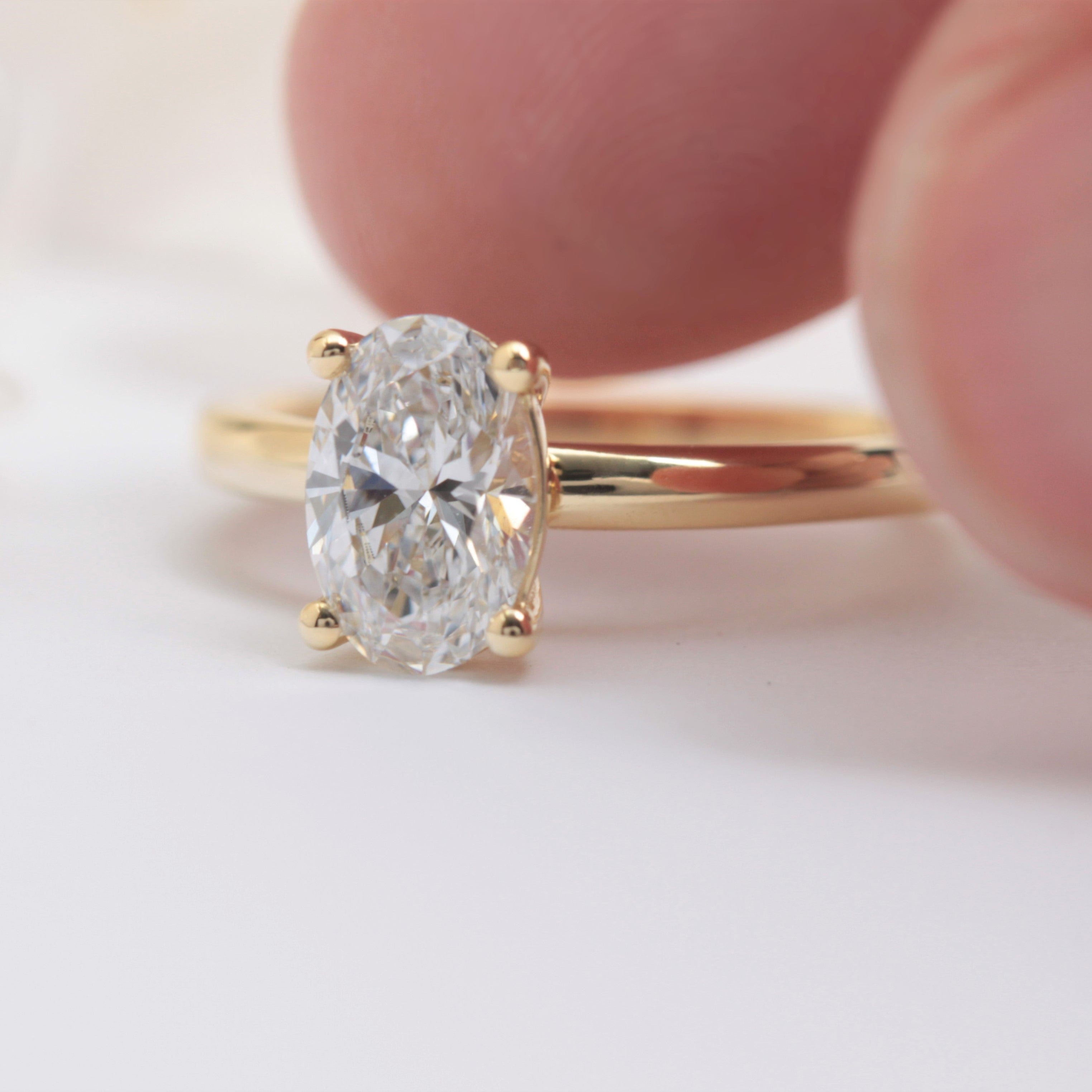 oval solitaire lab diamond engagement ring yellow gold