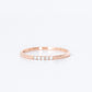 thin diamond wedding band with 5 small diamonds in rose gold