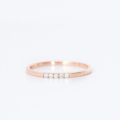 thin diamond wedding band with 5 small diamonds in rose gold