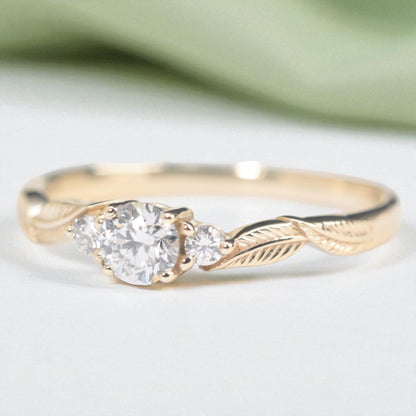 three-diamond-leaf_ngagement-ring-with-sage-background-Photoroom